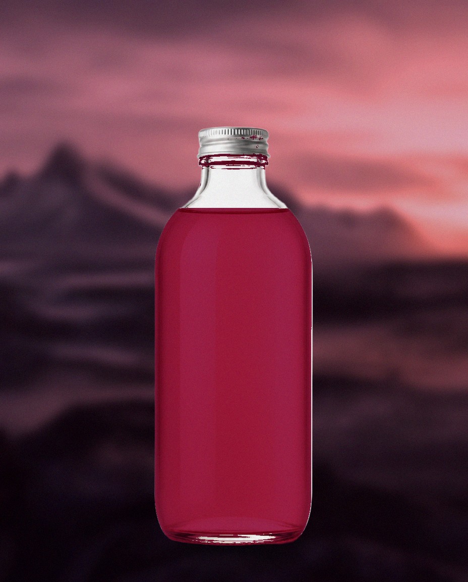 Glóða Flow Wild Berry kombucha bottle before dusk-lit Icelandic mountains